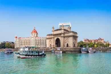 the gateway of india and boats as seen from the mumbai harbour in mumbai, india