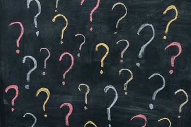 colorful question marks on chalkboard background. close up.