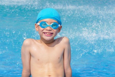 young asian boy happy at swimming pool