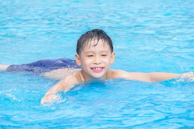 young asian boy happy at swimming pool
