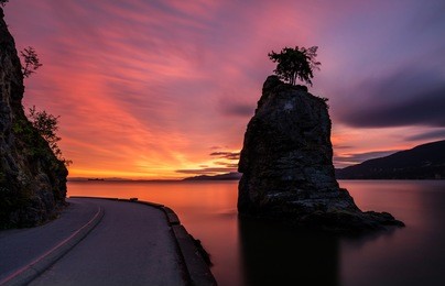 siwash rock at sunset along the sea wall in stanley park, vancouver, british columbia, canada.