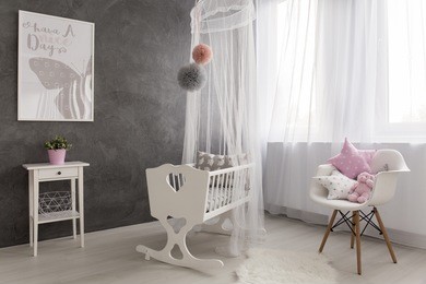 shot of a cozy baby girl room with a big window