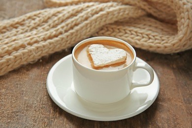 cup of coffee with marshmallow on wooden table