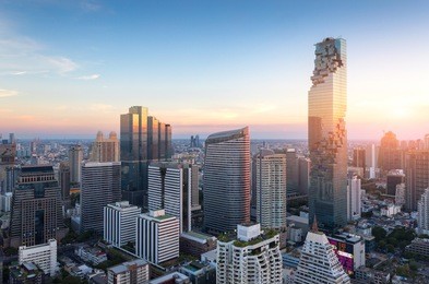 aerial view of bangkok modern office buildings, condominium in bangkok city downtown with sunset sky , bangkok , thailand