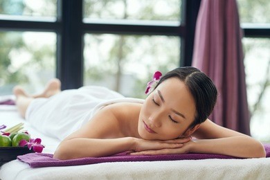 beautiful asian woman sleeping after relaxing spa procedure