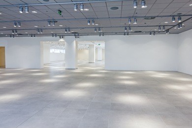 view on large showroom in a modern business centre with ceiling lamps.
