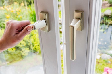 woman opens window for ventilation