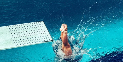 female diver jumping from platform, high angle view