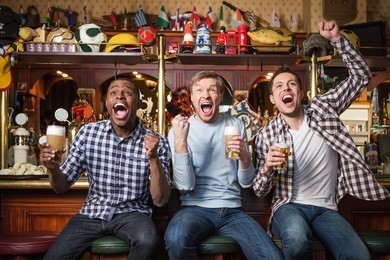 emotional fans with a beer at a bar