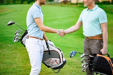 golfers shake hands with each other