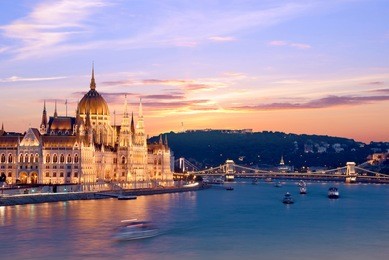 the picturesque landscape of the parliament and the bridge over the danube in budapest, hungary, europe at sunset