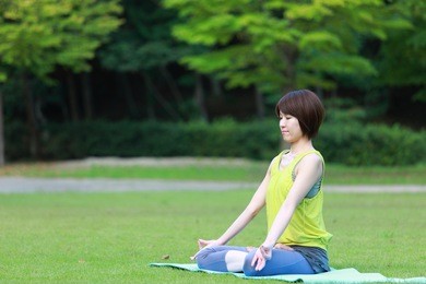 japanese woman outside doing meditation