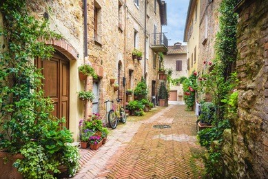 flowery streets on a rainy spring day in a small magical village pienza, tuscany.