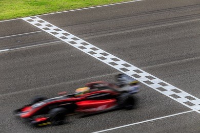 race car racing on speed track with motion blur
