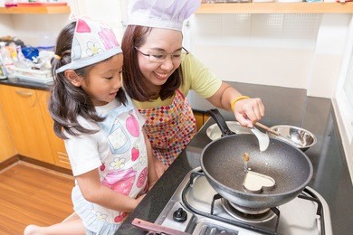 asian family enjoy making pancake, asian mother and daughter enjoy making bakery cake,asian mom teaching daughter to learn making pancake in real life kitchen at home