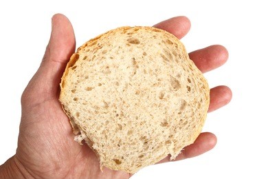 hand holding half of graham bread roll.