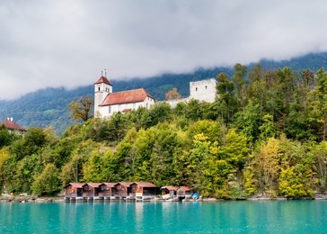 waterside view of castle on  lake brienz, interlaken.