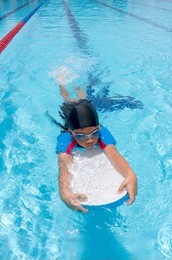 asian boy practice swimming.