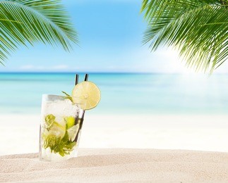 summer mojito drink with blur beach on background. copyspace for text