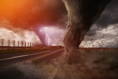 view of a large tornado destroying a road
