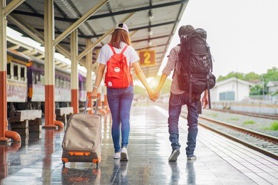 happy young couple on railway station platform