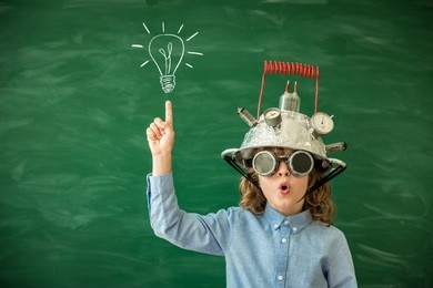 back to school. schoolchild with virtual reality headset. child in class. funny kid against blackboard. nerd kid having fun. geek child with vr glasses. innovation technology and education concept