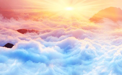 bright saturated colors dawn above the sea of fog over the tops of the carpathian is fabulously beautiful panoramic view, illuminated by the golden rays of the rising sun early in the morning
