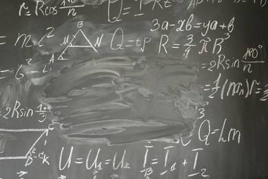 math formulas written in white chalk and copy space on black board