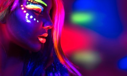 fashion model woman in neon light, portrait of beautiful model girl with fluorescent make-up, body art design of female disco dancer posing in uv, painted face, colorful make up, over black background