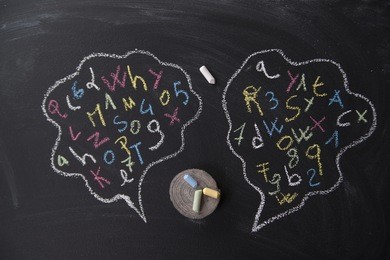 syllables of words into the clouds drawn on blackboard with chalk
