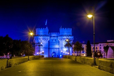 serrano towers (torres de serranos) at night. towers are located on plaza de los fueros in valencia, spain