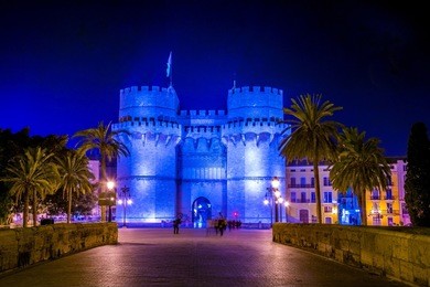 serrano towers (torres de serranos) at night. towers are located on plaza de los fueros in valencia, spain