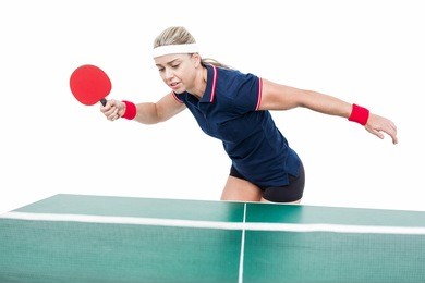female athlete playing ping pong on white background