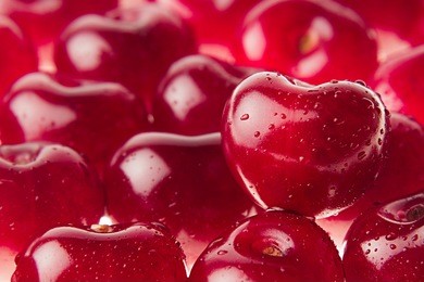 cherry background with cherry in form of heart. ripe fresh rich cherries with drops of water. macro. texture.   fruit background. valentine's day.