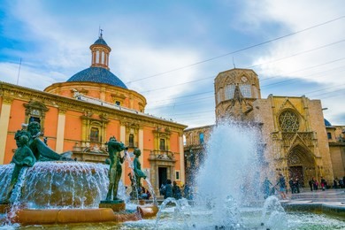 square of saint mary's with valencia cathedral temple, basilica de la nuestra senora de los desamparados and the rio tura fountain in old town.