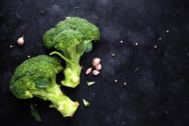 fresh broccoli on dark wooden
 table background. top view
