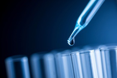 dropping chemical liquid to test tube, science research concept. 