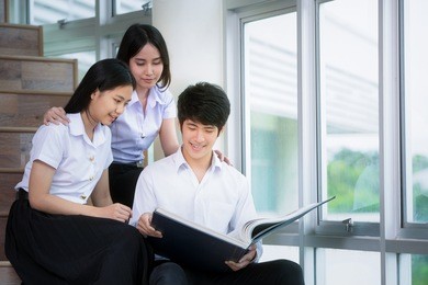 asia students group study in univercity and read a book in library