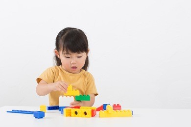 cute asian girl playing blocks