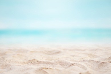 close up sand with blurred sea sky background, summer day, copy space or for product. summer background concept.