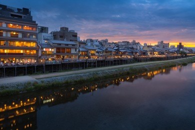 old house and restaurant in kamo river or kamogawa river at sunset, gion, kyoto, japan