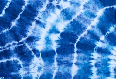 indigo tie dye pattern on cotton fabric abstract background.
