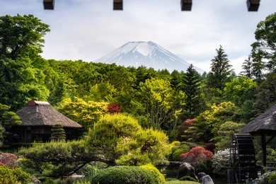 view from somewhere near oshino hakkai, japan with mt. fuji in the background and roof on the foreground

