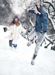 young couple playing outdoors. winter season.