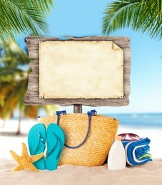 summer concept with empty wooden board and blank paper for message. tropical sandy beach on background.