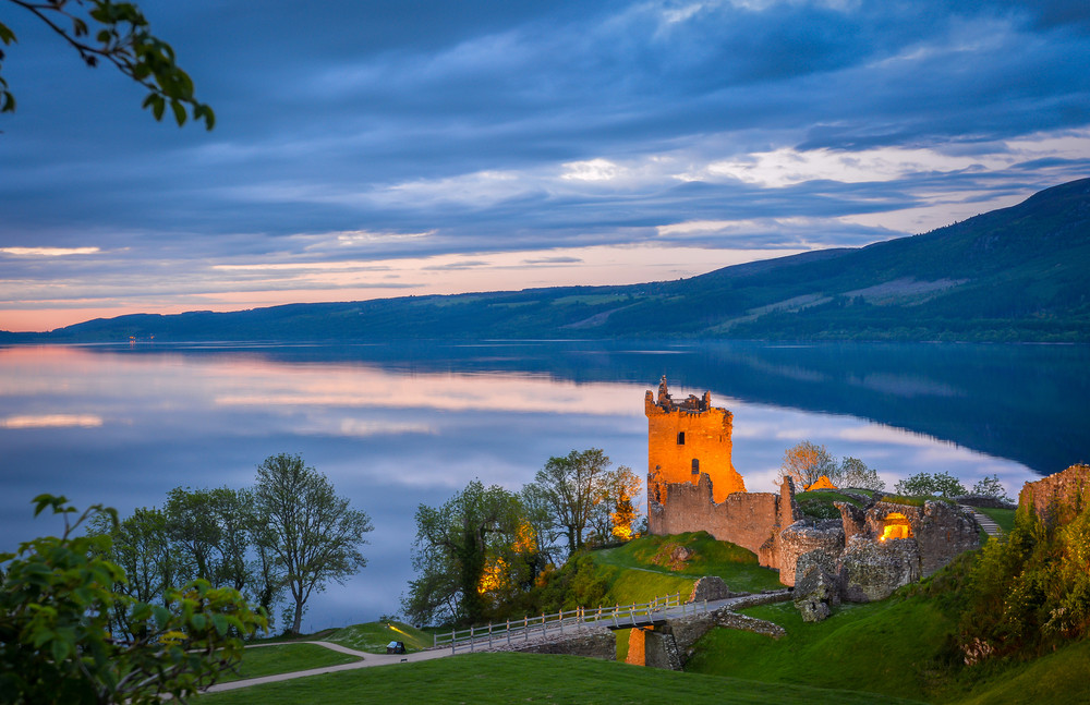 closeup panoramic view of urquhart castle. the castle sits beside loch ness, near inverness and drumnadrochit, in the highlands of scotland. only the tower of the castle is in focus; the rest is blur.