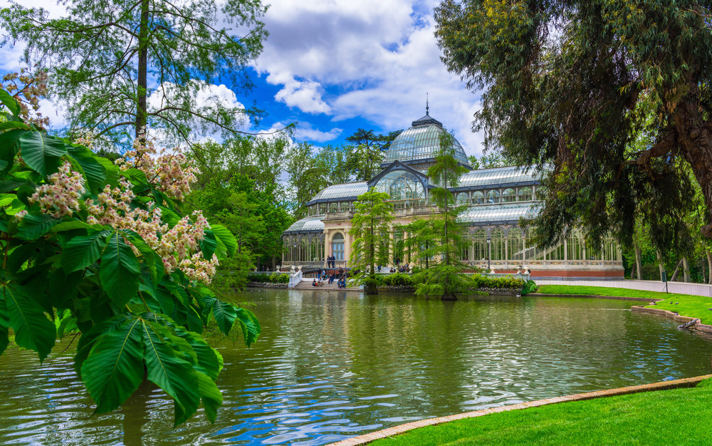 crystal palace (palacio de cristal) in retiro park in madrid, spain. architecture and landmark of madrid, postcard of madrid 