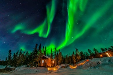 aurora borealis flying over the chalet in yellowknife 