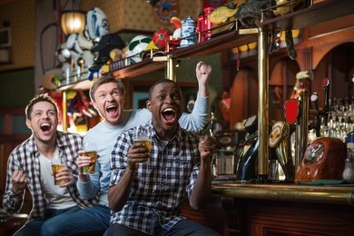 shouting fans with beer in bar