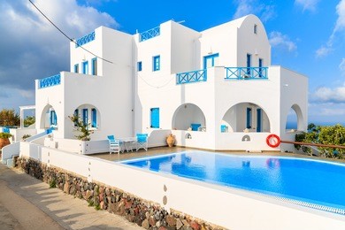 beautiful holiday apartments with swimming pool in imerovigli village with typical white greek architecture, santorini island, greece